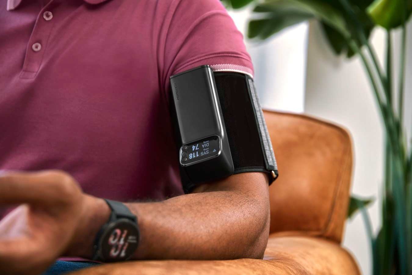 Garmin Index BPM smart blood pressure monitor worn on the upper arm displaying blood pressure readings